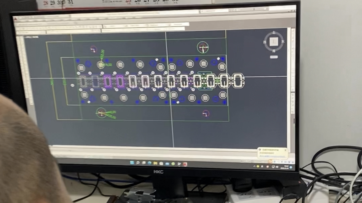 Stamping die designer is making drawings with CAD