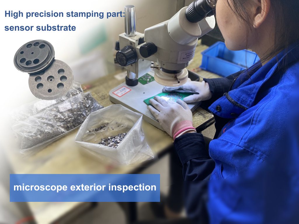 Metal stamping quality inspector in China is using microscope instruments for surface inspection of precision stamped sensor substrate for automobile industry.
