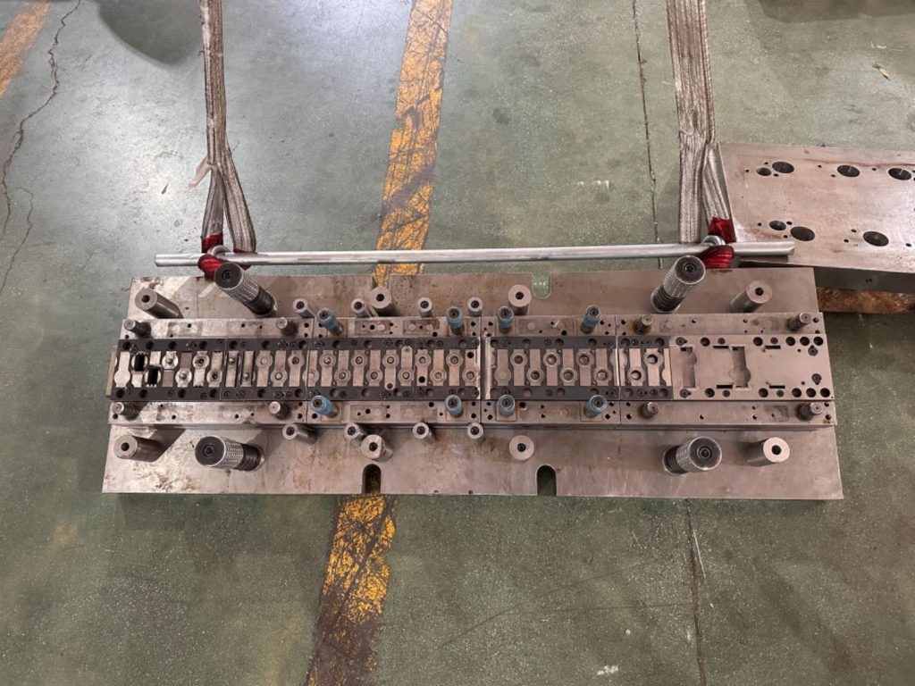 A stamping mold being assembled, featuring deep draw stamping, designed for large-scale progressive die