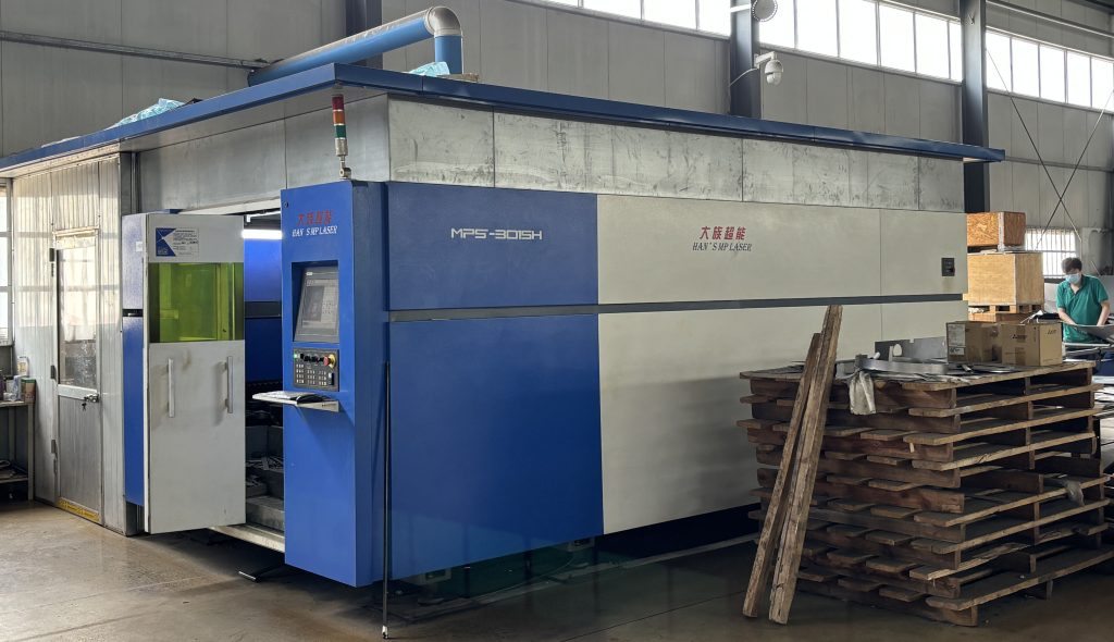 Full view of a large laser cutting machine in a sheet metal processing factory